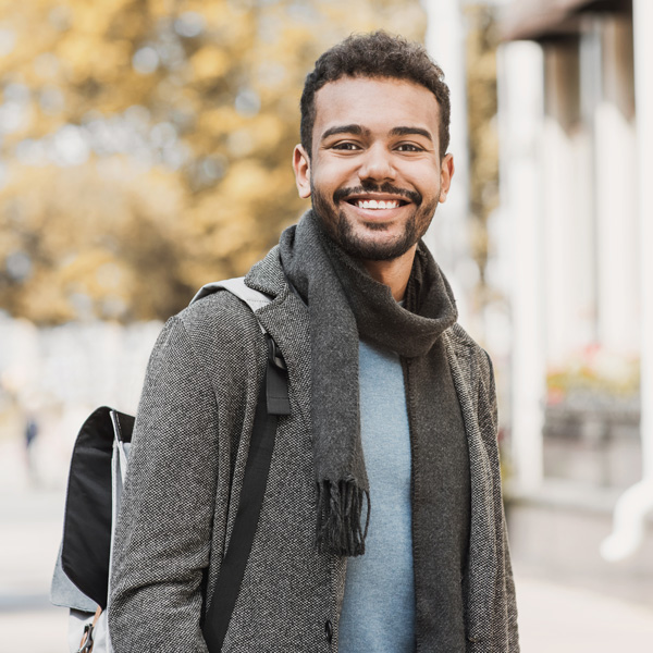 man in jacket and scarf smiling